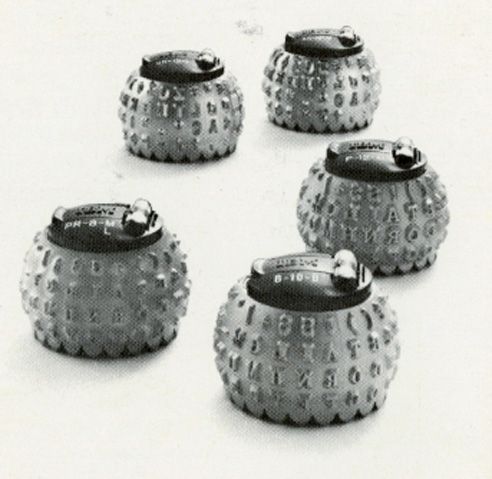 A black and white photo of a group of objects with letters on them