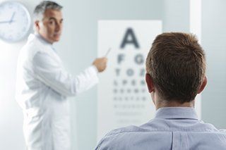 eye doctor performing vision test