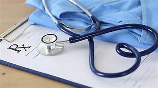 A stethoscope is sitting on top of a clipboard with a prescription written on it.