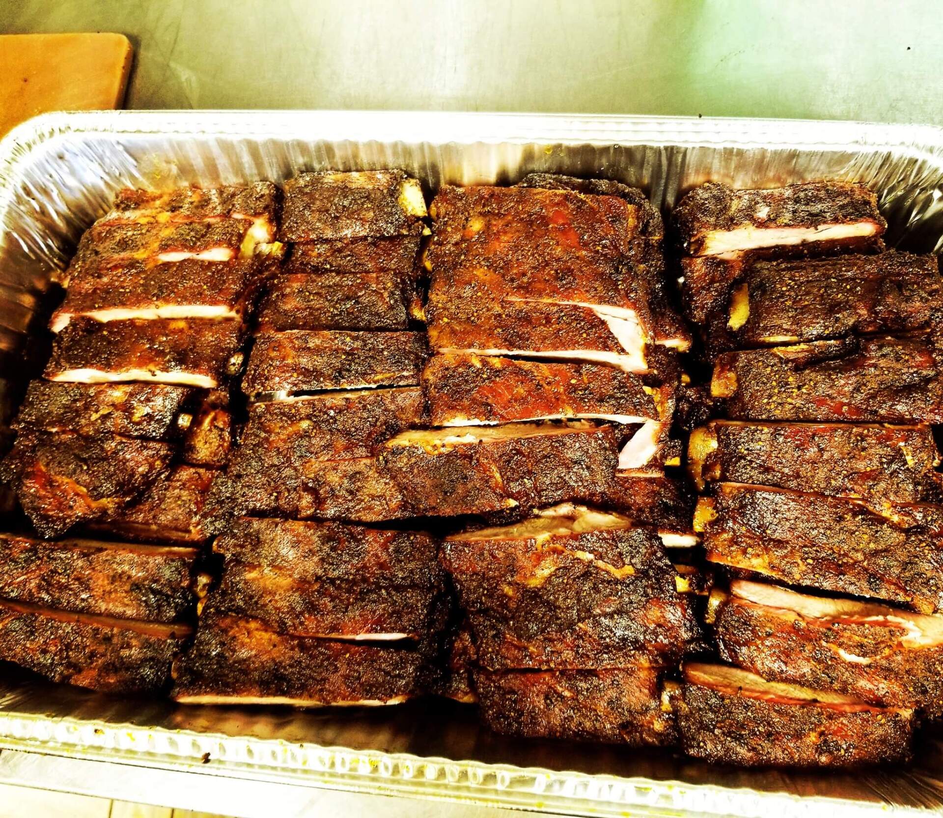 A tray of ribs is sitting on a table
