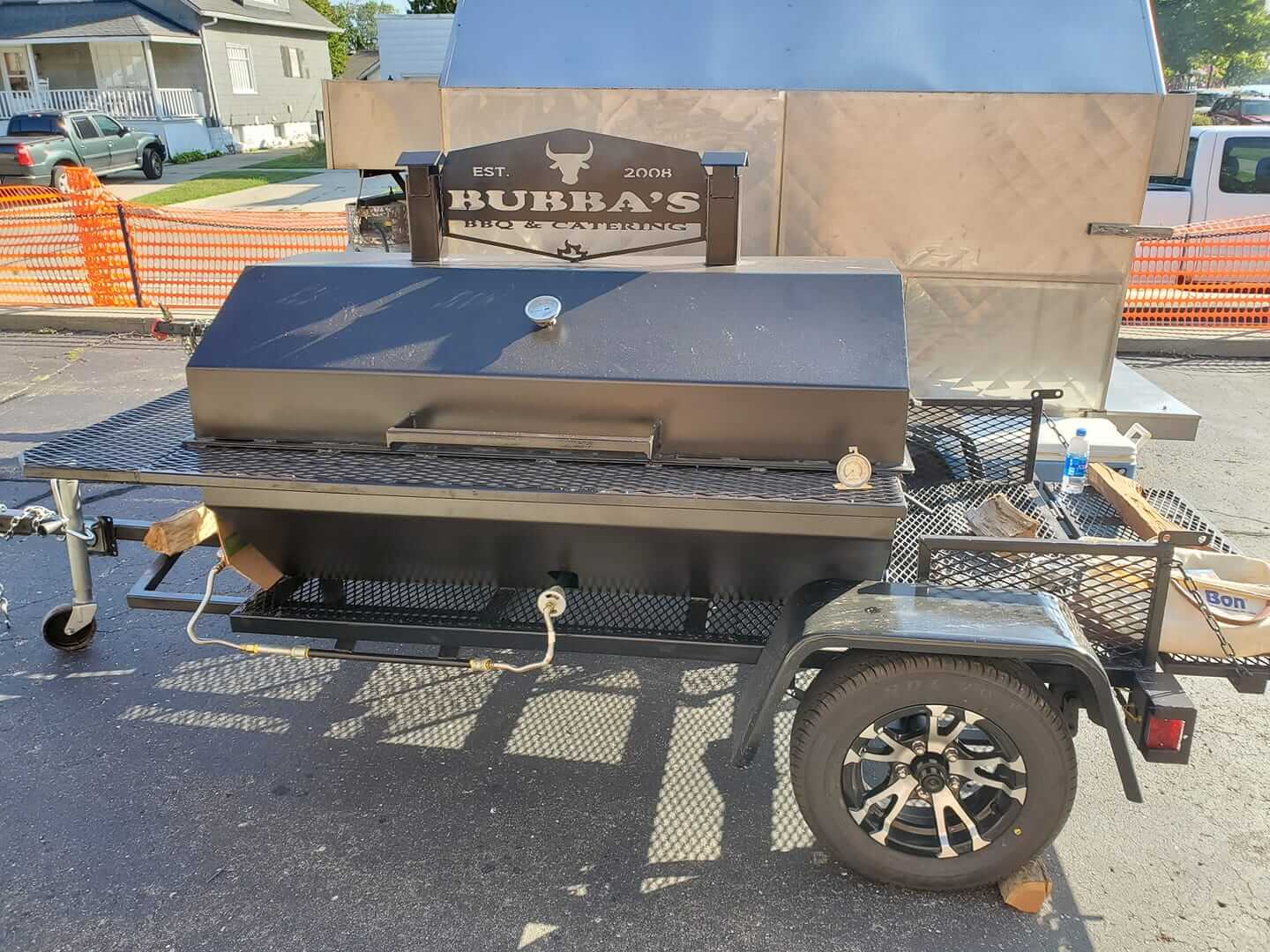 A bbq grill on a trailer that says bubba's on it