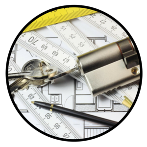 A cylinder lock, keys, a black pen, and folding rulers placed over architectural floor plans.