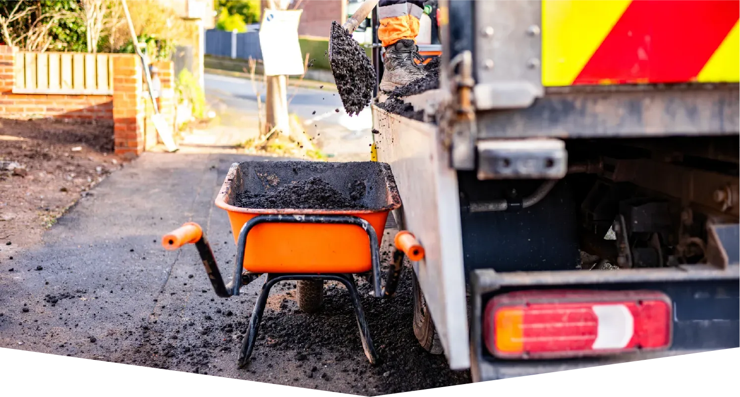 A brick chimney on top of a roof with a blue sky in the background.