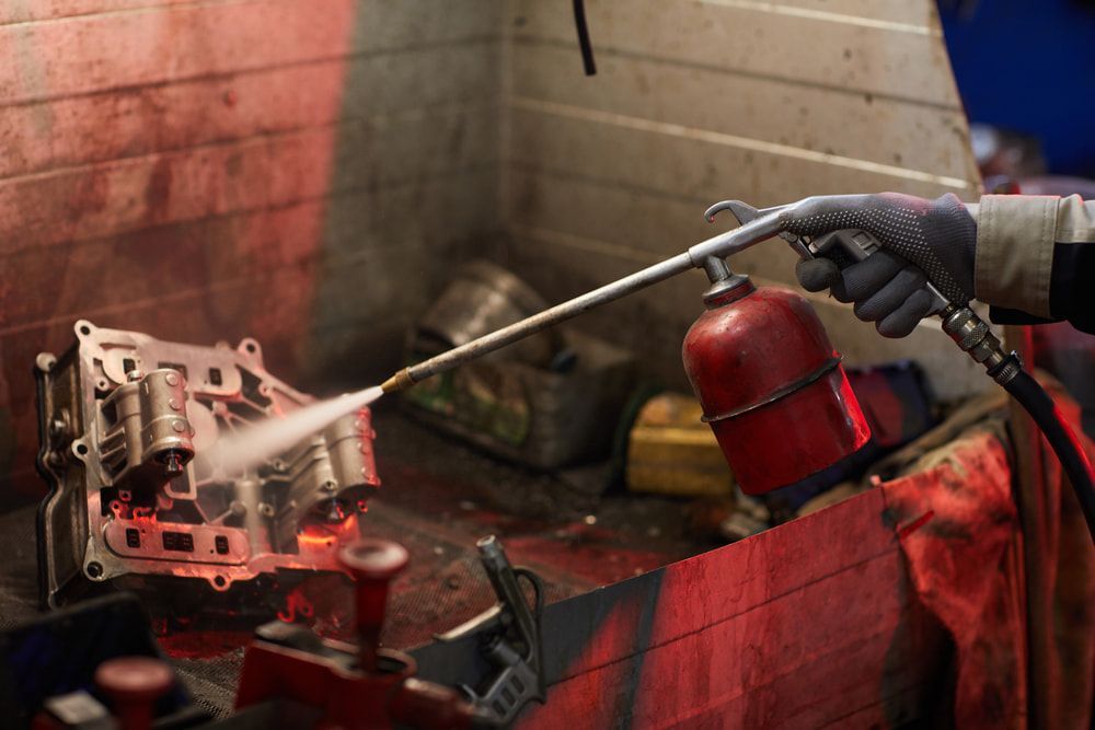A Man Removing Contaminated Fuel  — Coffs Auto Service in North Boambee Valley, NSW