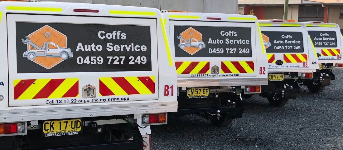 A Row of Coffs Auto Service Trucks Parked Next to Each Other — Coffs Auto Service in North Boambee Valley, NSW