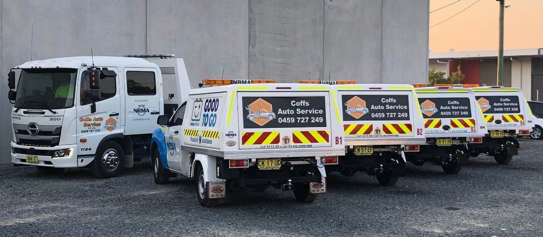 Auto Services Work Utes parked in front of wall with Truck  — Coffs Auto Service in North Boambee Valley, NSW
