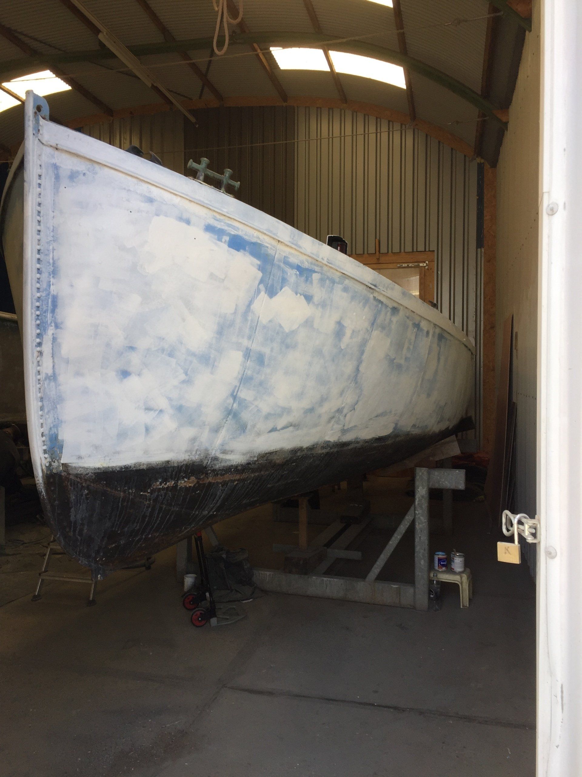 boat on stands in a workshop being restored