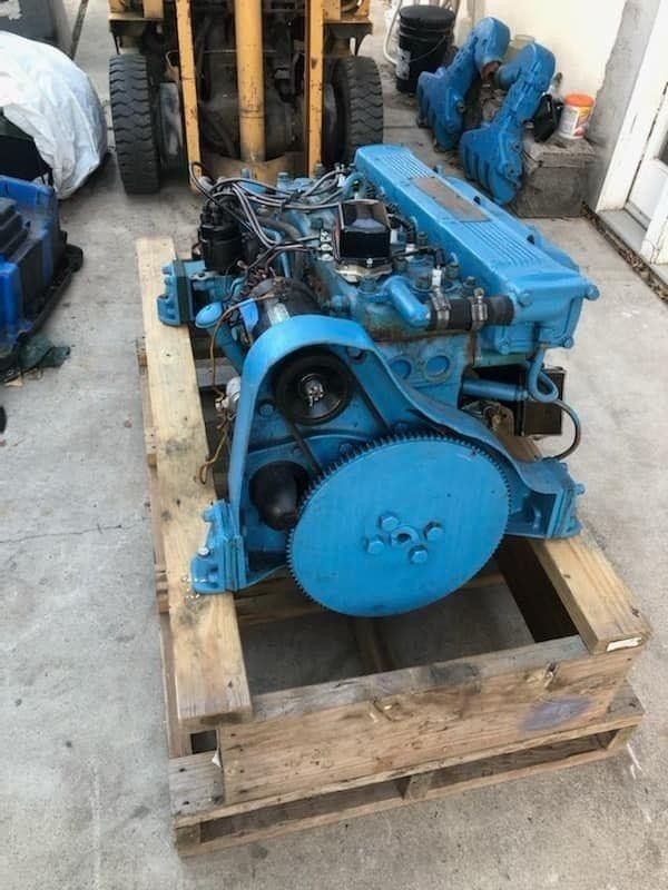 a boat engine supported on a wooden cradle