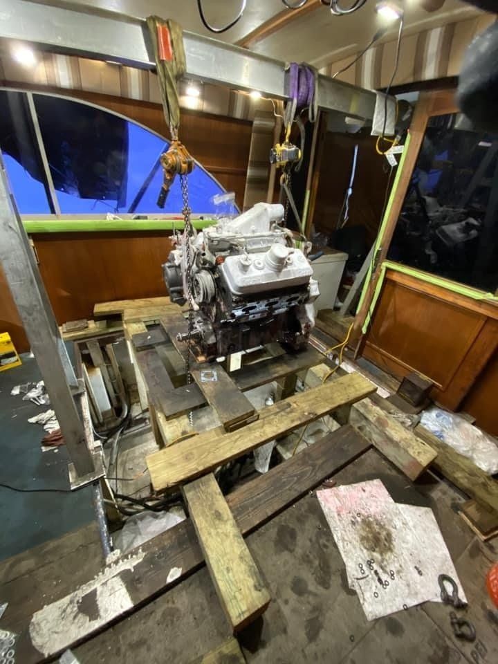 a boat engine supported on a wooden plank 