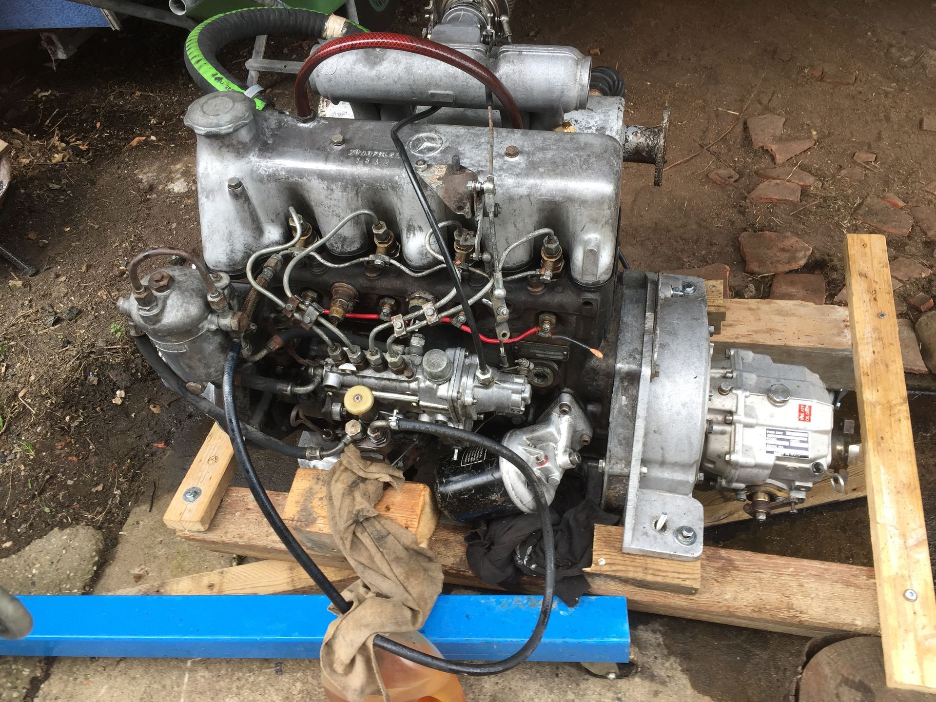 a boat engine supported on a wooden cradle