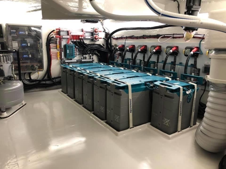 a bunch of batteries are sitting in a room on a boat .