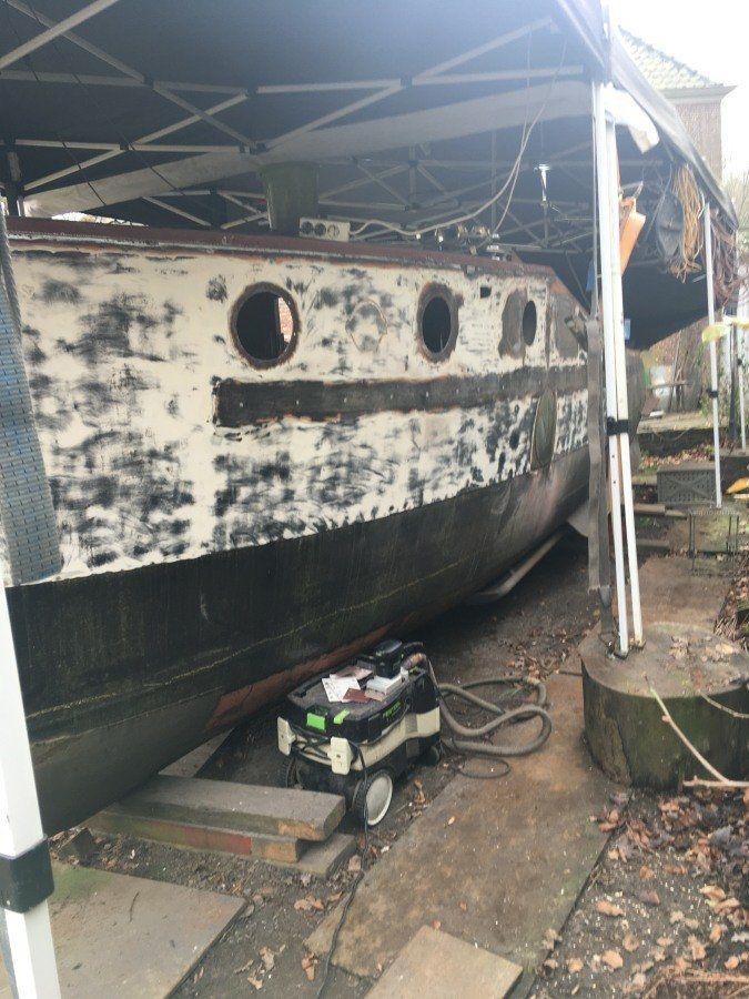 a boat named Michiel de Ruyter being restored in dry dock
