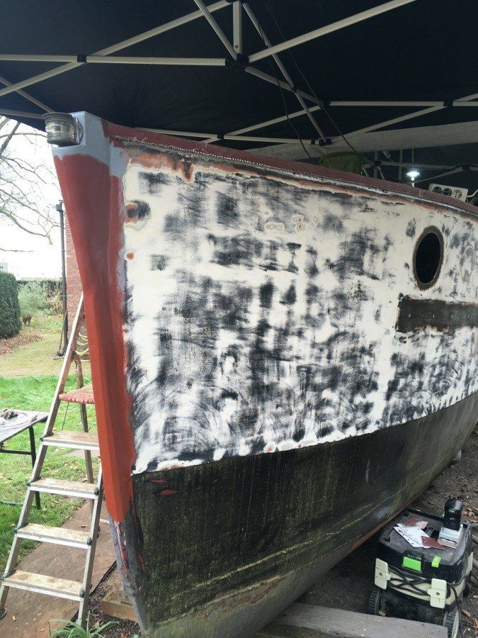 a boat named Michiel de Ruyter being restored in dry dock