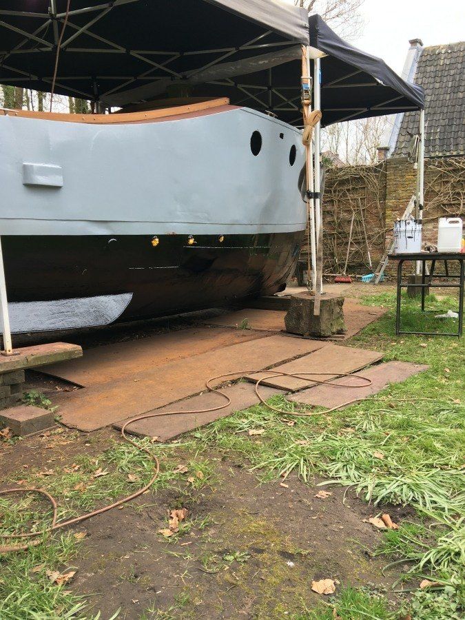 a boat named Michiel de Ruyter being restored in dry dock