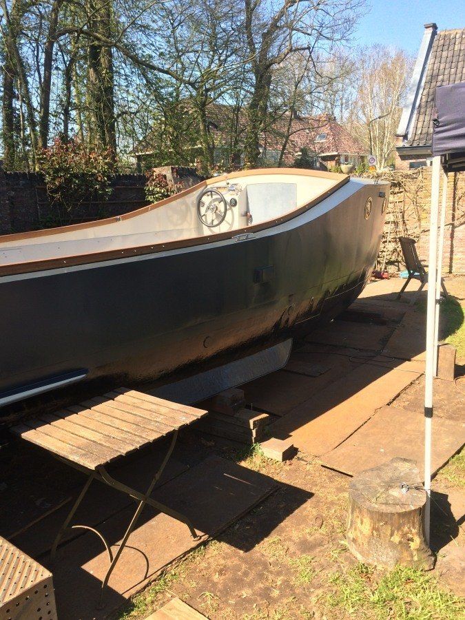 a boat named Michiel de Ruyter being restored in dry dock