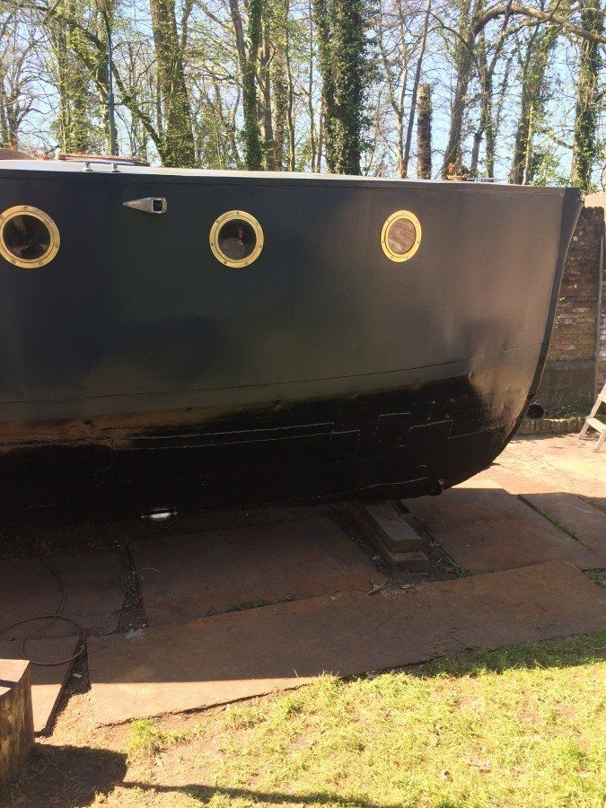 a boat named Michiel de Ruyter being restored in dry dock