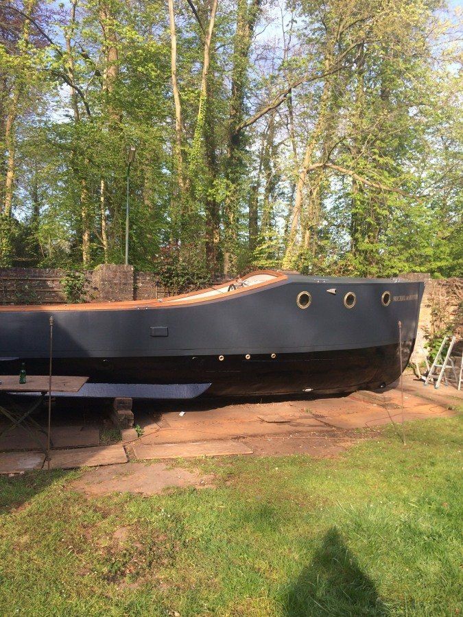 a boat named Michiel de Ruyter fully restored, being hoisted back into the water