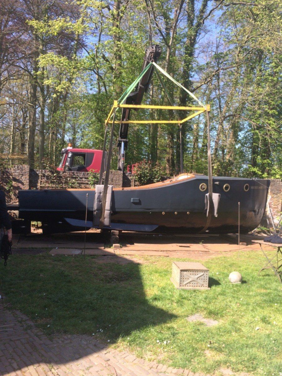 a boat named Michiel de Ruyter being restored in dry dock