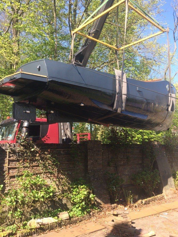 a boat named Michiel de Ruyter fully restored, being hoisted back into the water