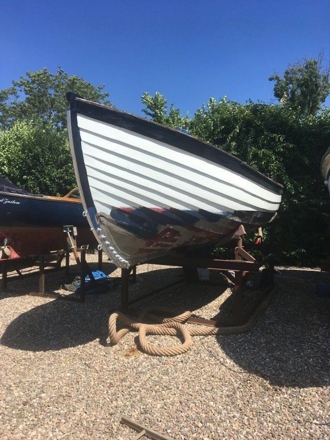 wooden sloop restored and painted white