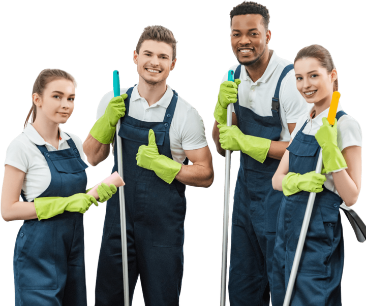 Four diverse cleaners in blue overalls and gloves, holding mops, smiling.