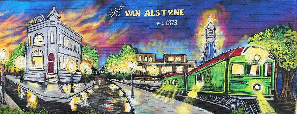 Mural depicting Van Alstyne, Texas, featuring a building, train, and buildings along a street at night, with a colorful sky.