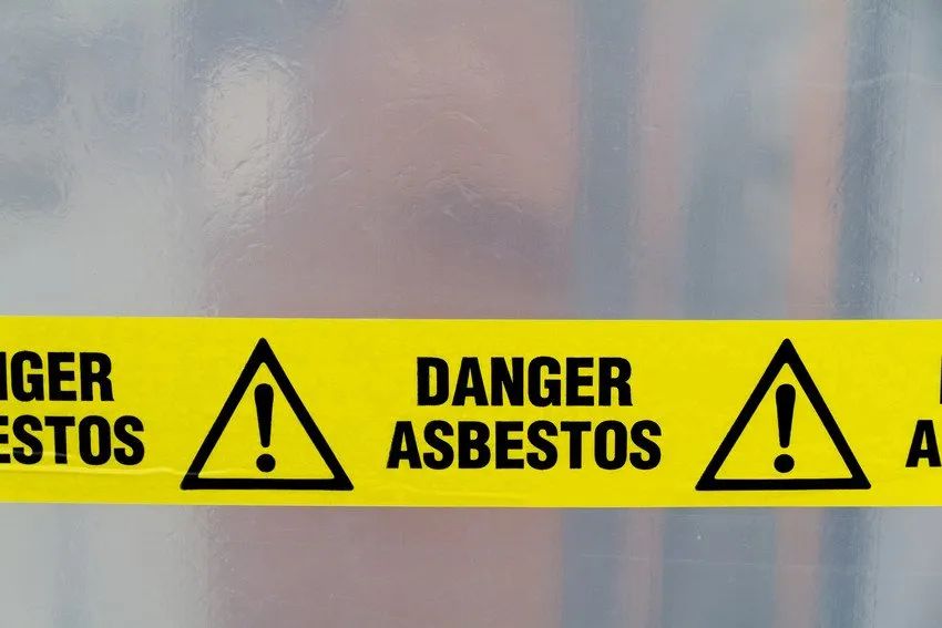 Yellow tape displaying the text 'Danger Asbestos' 