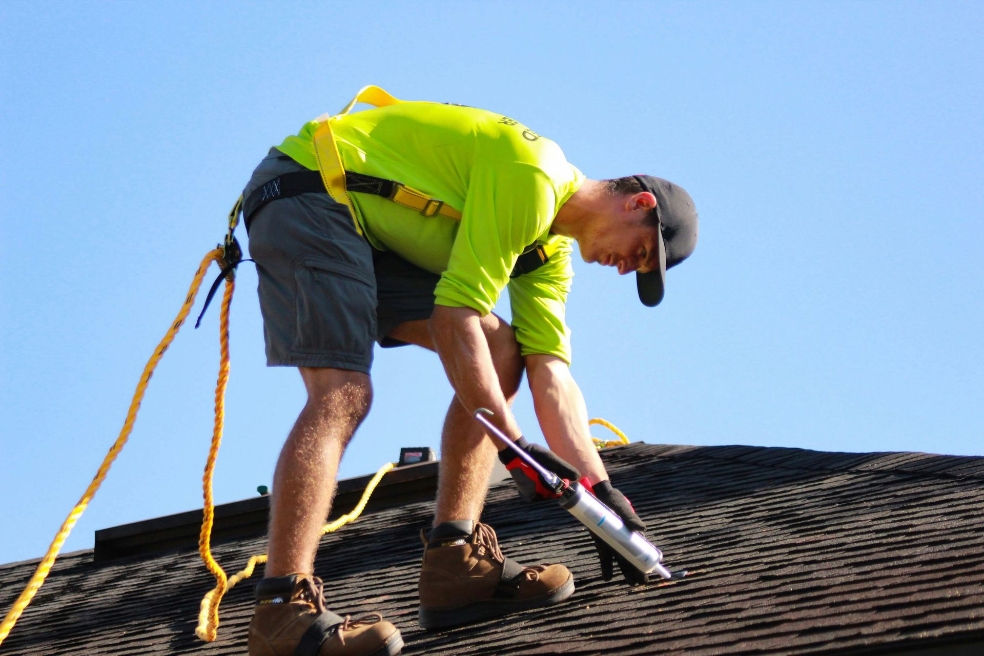 Man on roof working on a solar panel installation
