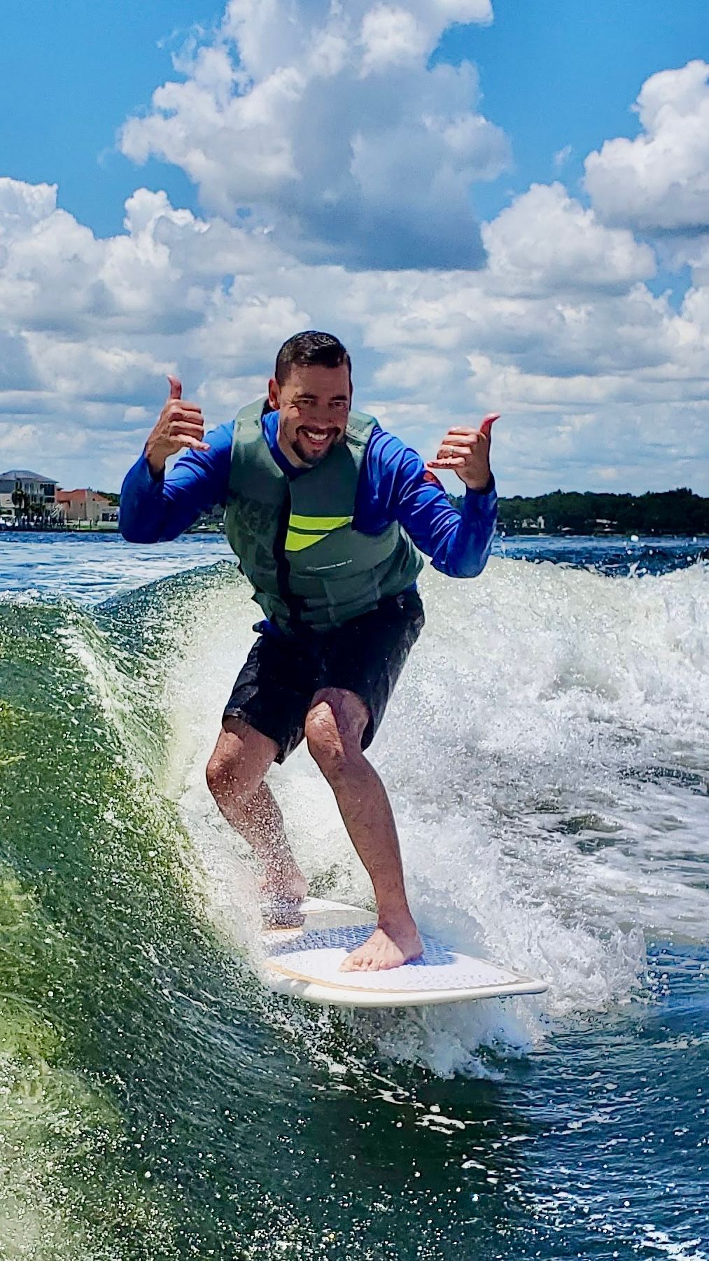 A man is riding a wave on a surfboard in the water.