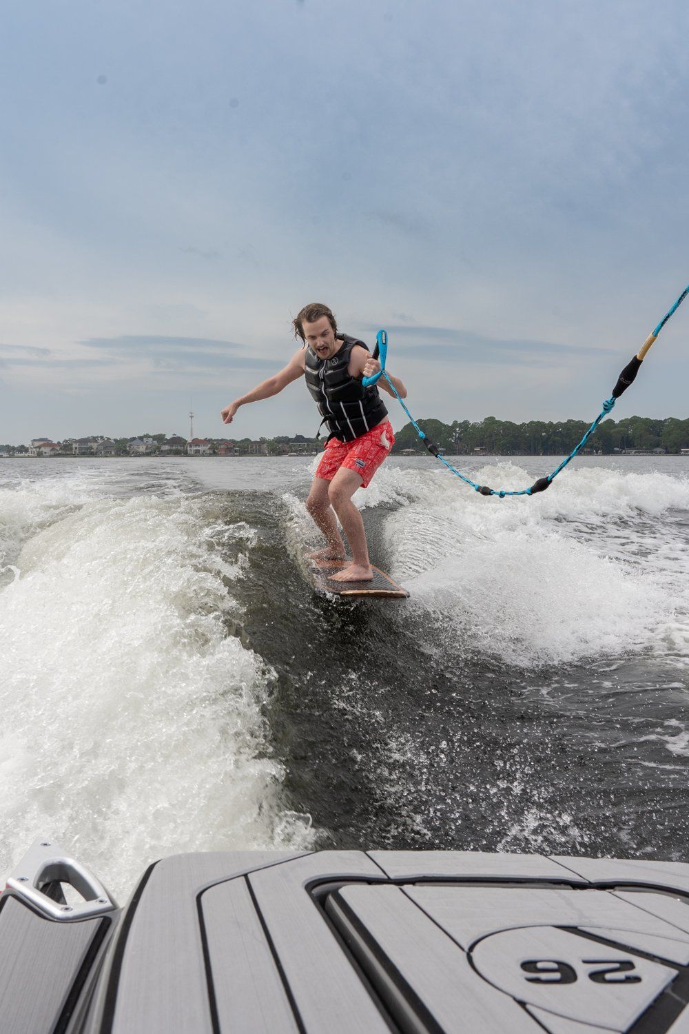 A man is riding a wave on a surfboard in the water.