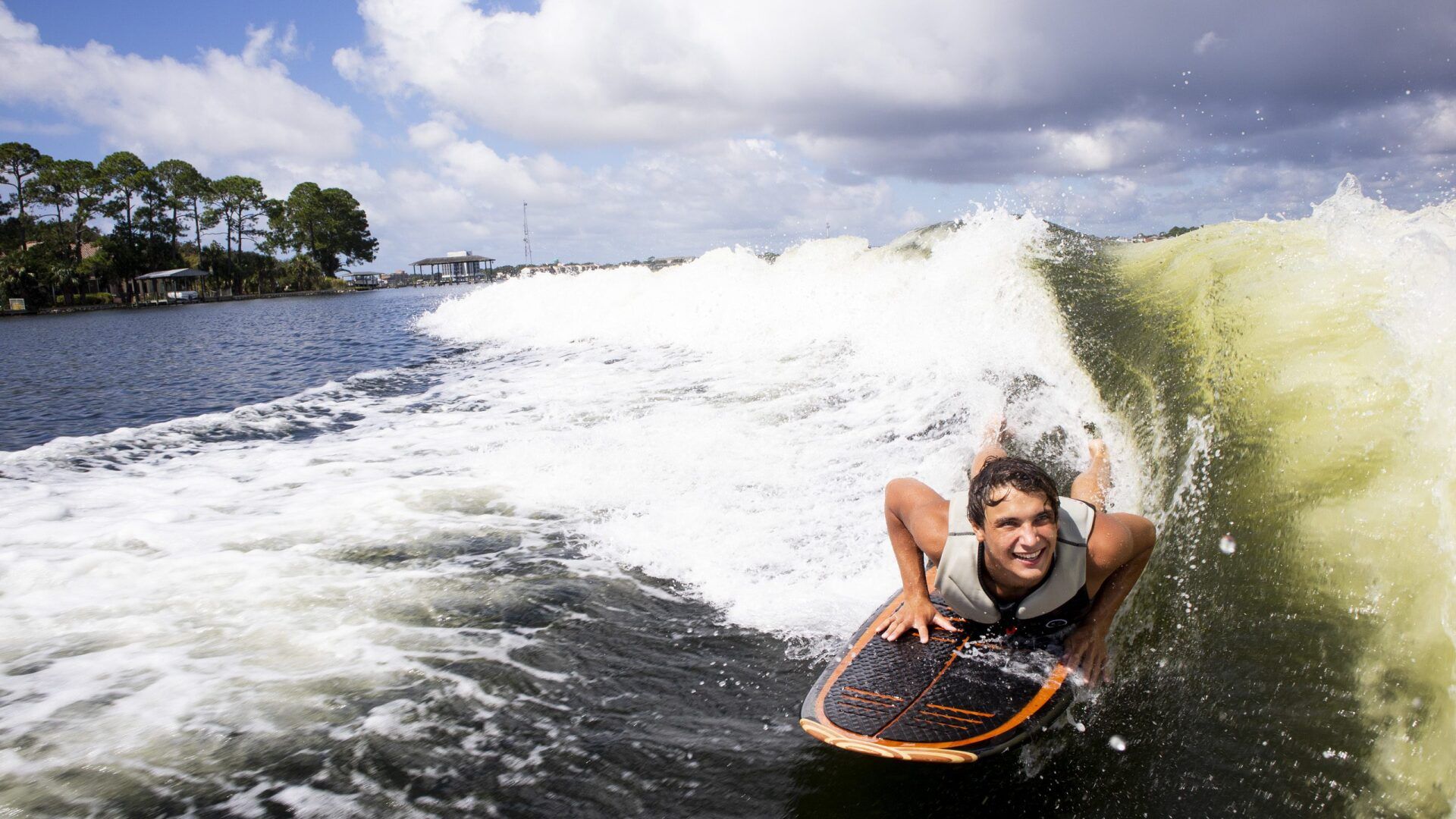 woman lying on board while wakesurfing