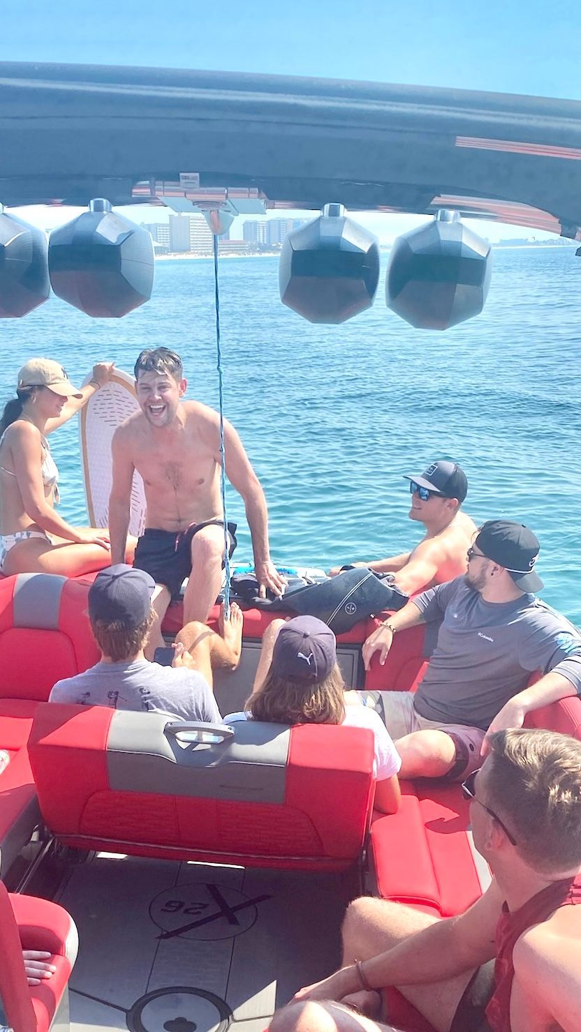 A group of people are sitting on a boat in the water.