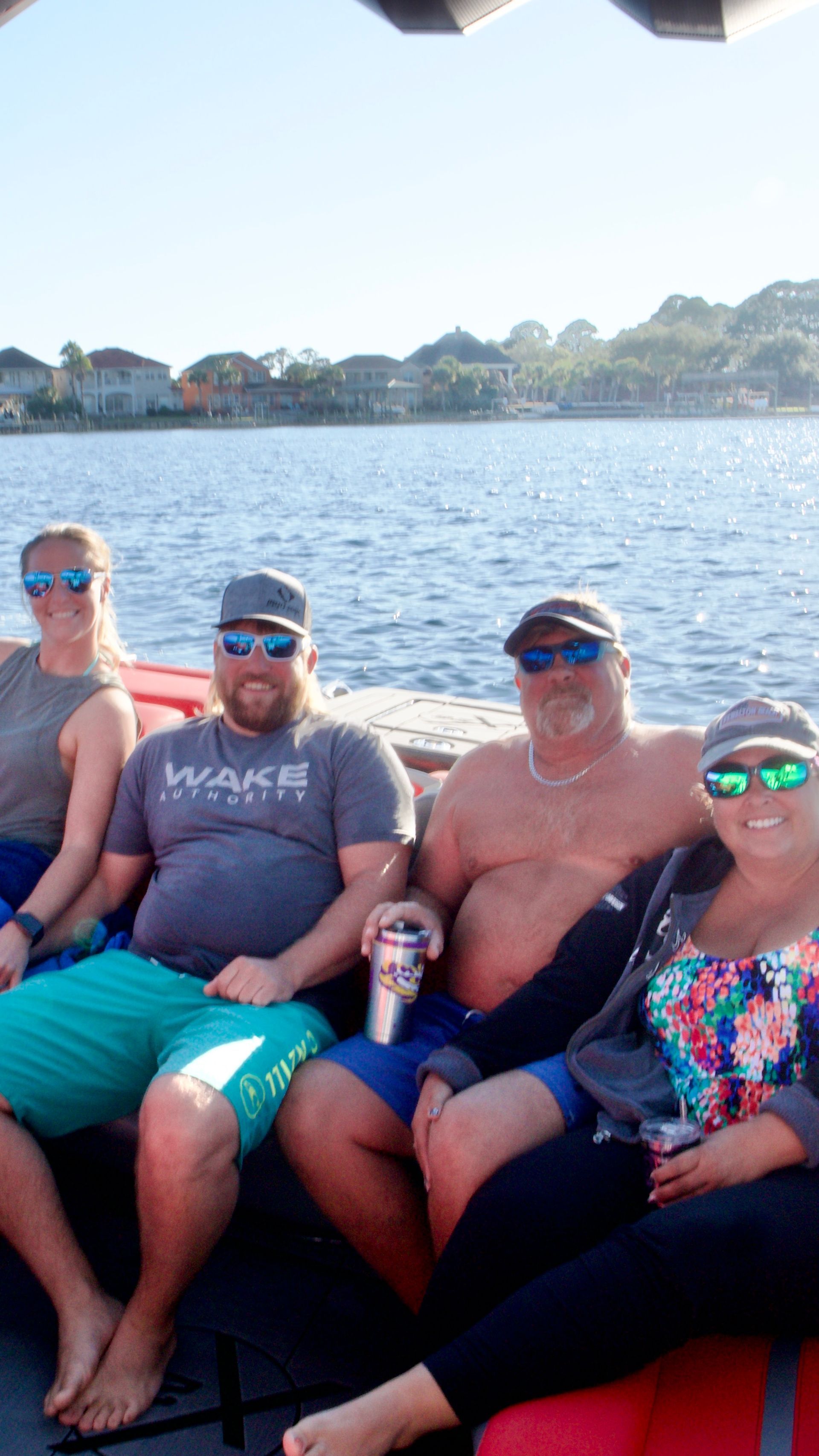 A group of people are sitting on a boat in the water.