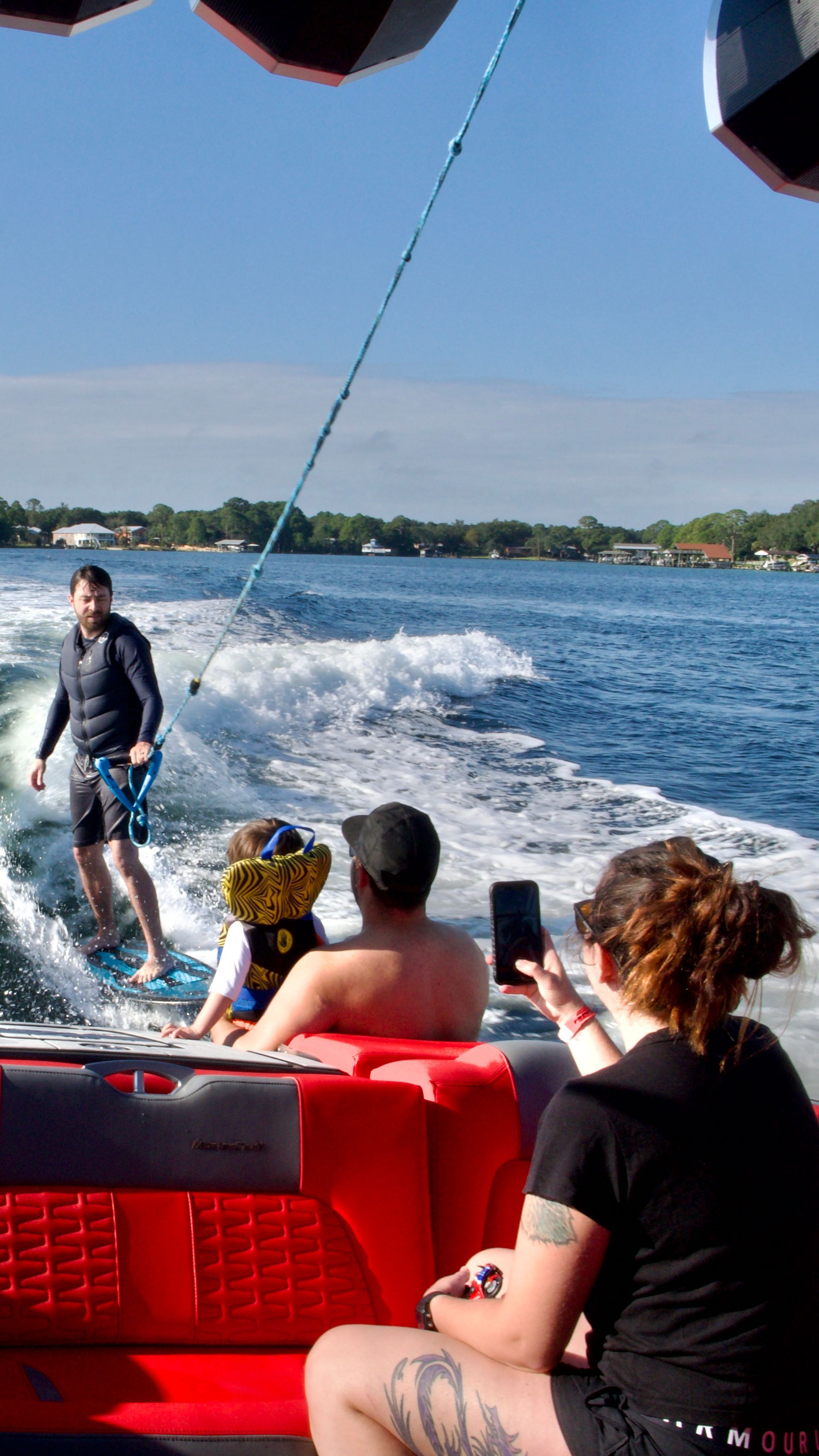 A group of people are riding a boat on a lake.