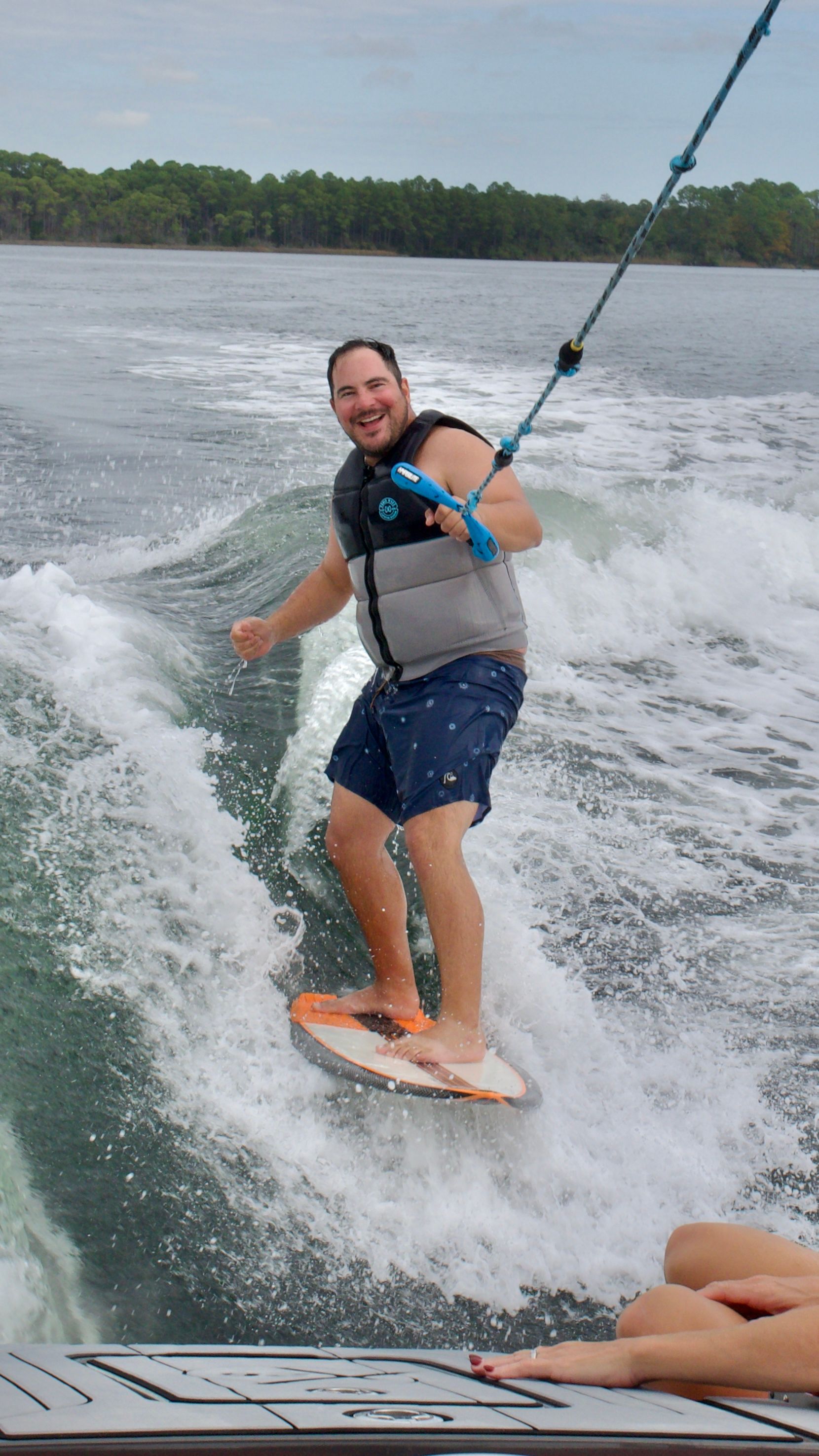 A man is riding a wave on a wakeboard in the water.