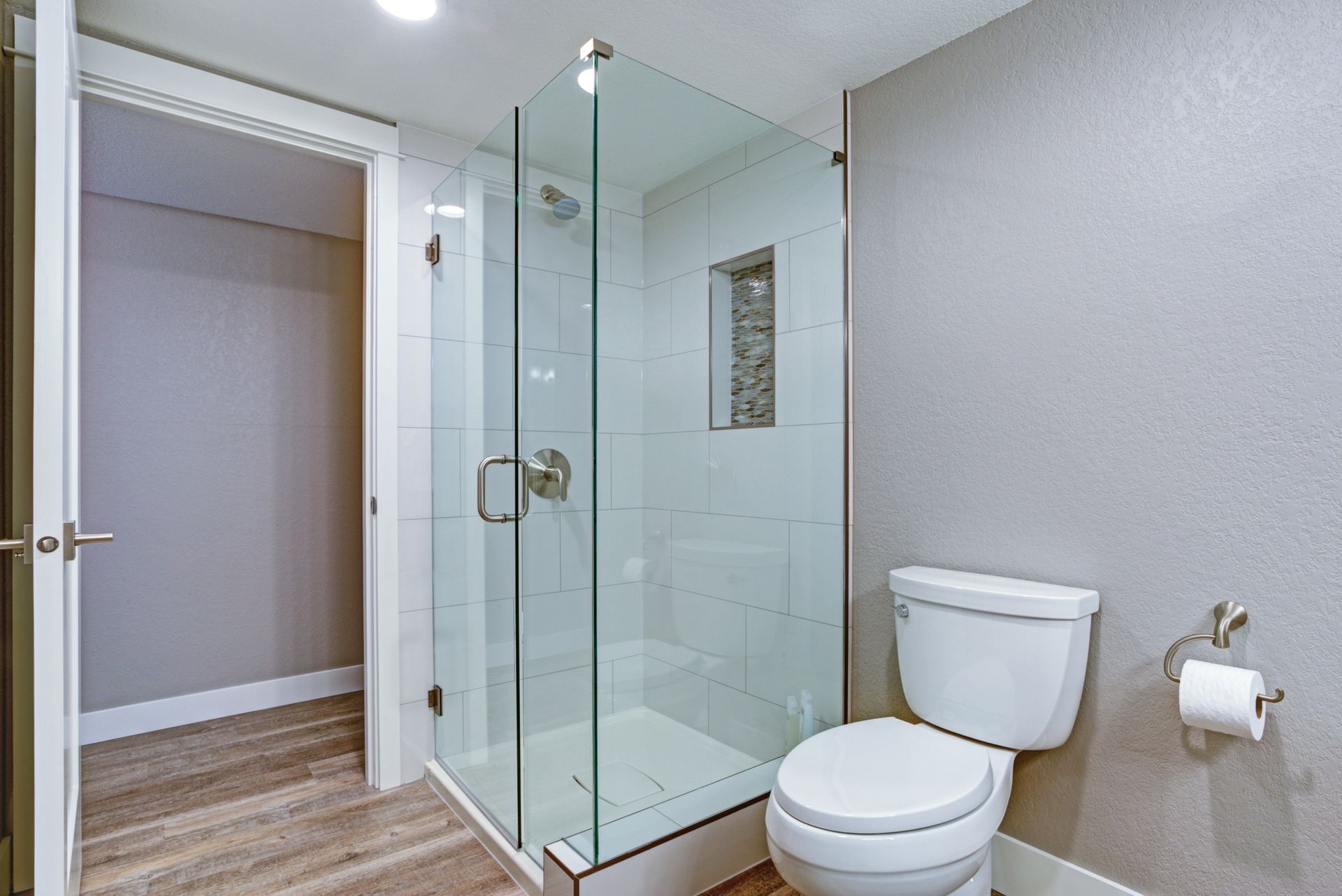 An elegant bathroom with a frameless shower door.