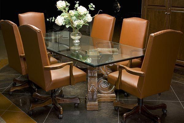 A dining room table with a vase of flowers on it