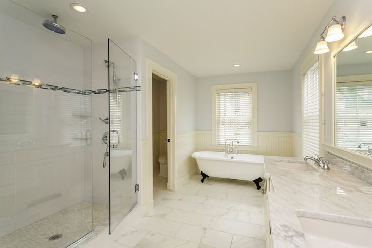 Luxury master bathroom with clawfoot tub, glass walk-in shower, and marble countertops.