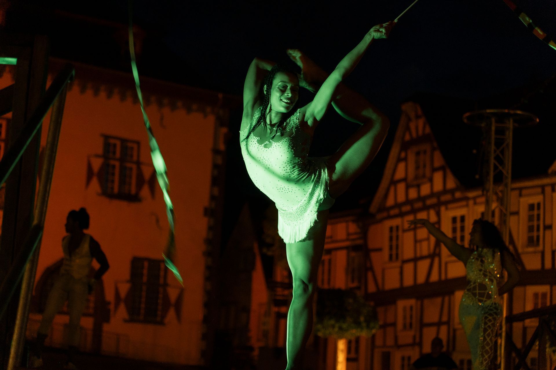 Street scene: People pose with a giant butterfly costume. A woman takes a photo.