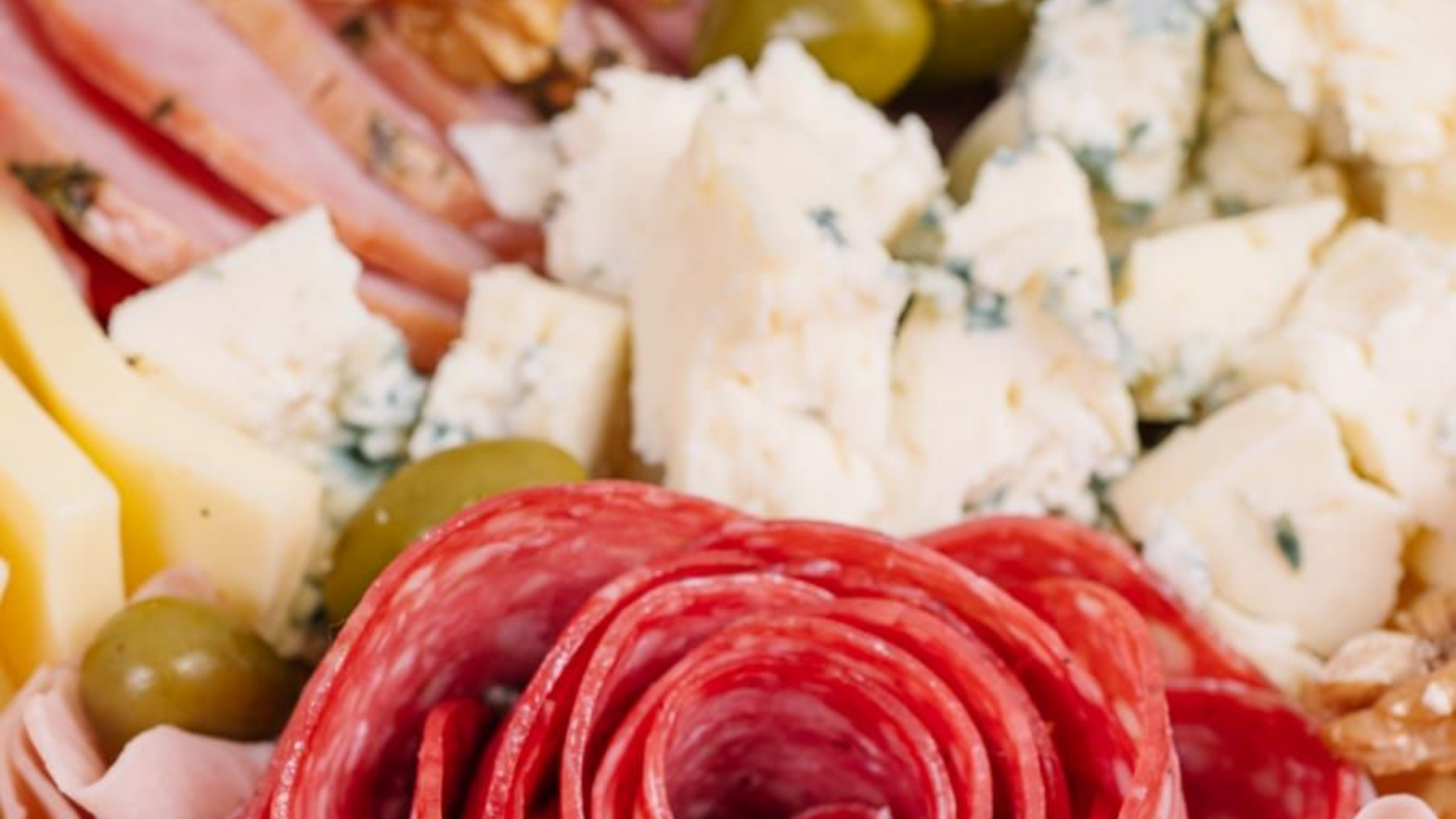 Tabla de embutidos con salami, queso, aceitunas y embutidos.