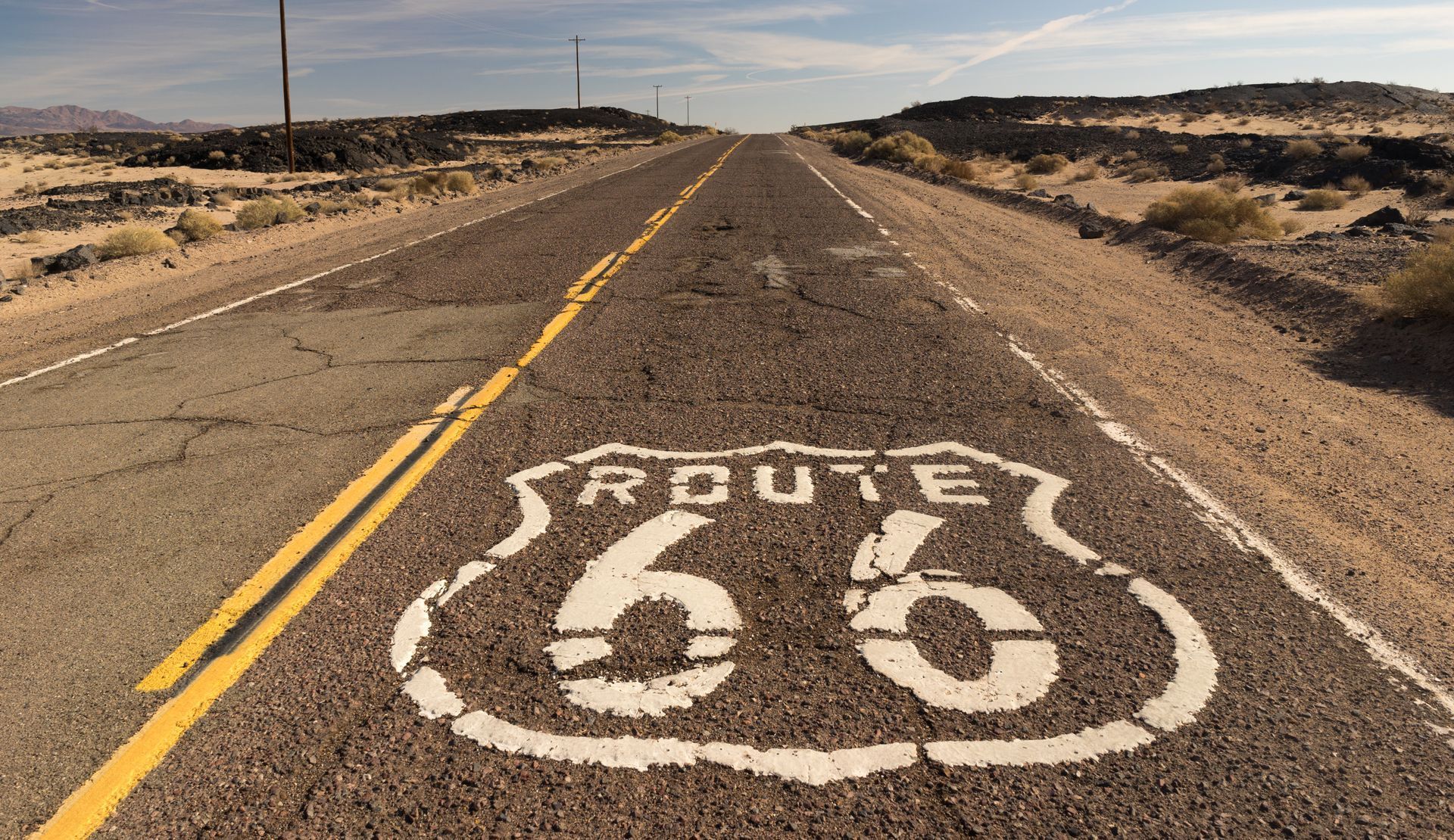Route 66 is painted on the side of the road