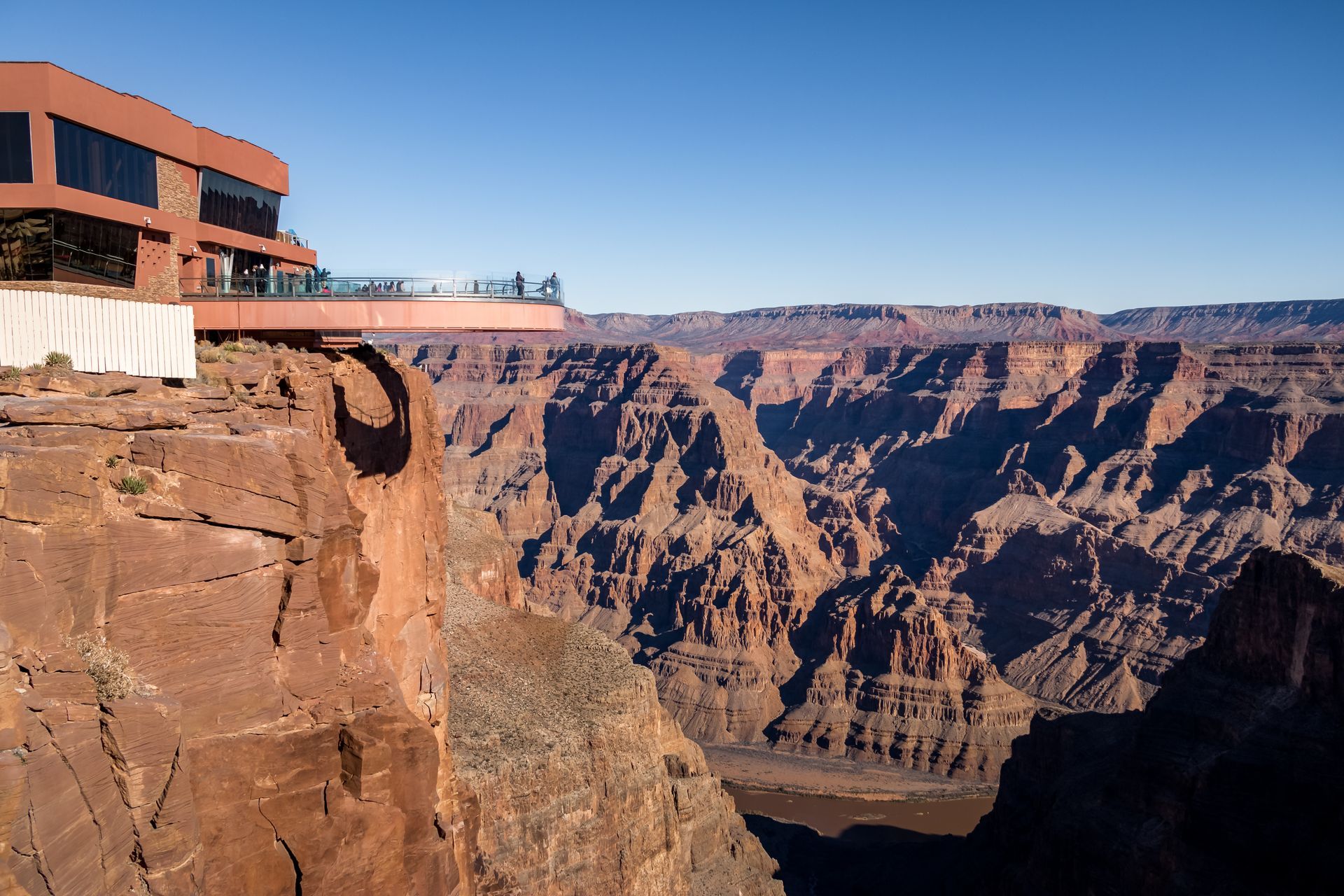 A building on a cliff overlooking the grand canyon