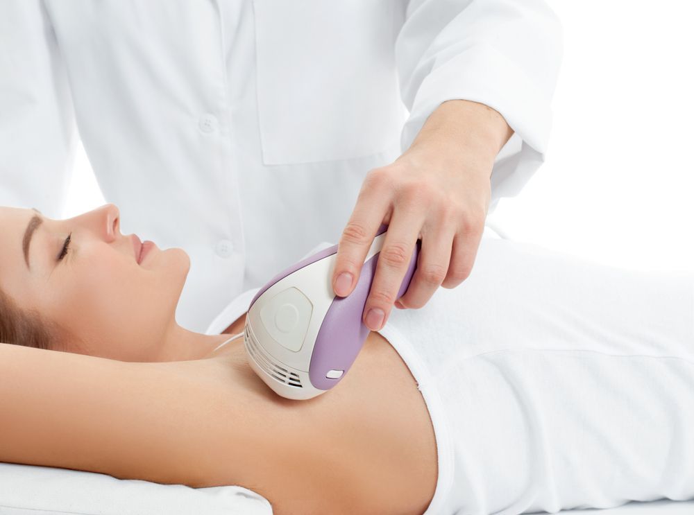 Hand Holding a Purple and White Handheld Device — A9 Skin and Hair Clinic In Westmead, NSW