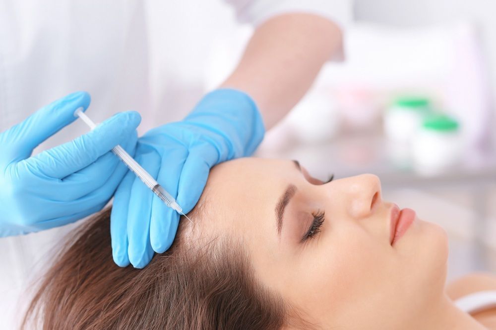 Gloved Hands Injecting A Woman’s Forehead — A9 Skin and Hair Clinic In Westmead, NSW
