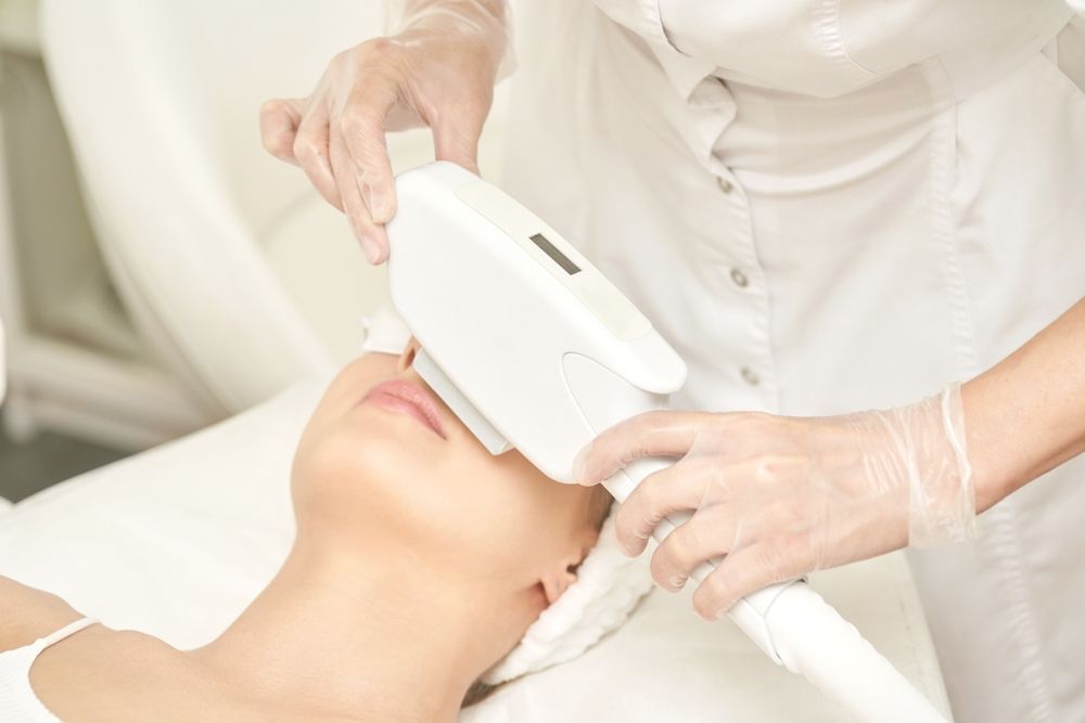 Esthetician Using a White Handheld Device — A9 Skin and Hair Clinic In Westmead, NSW