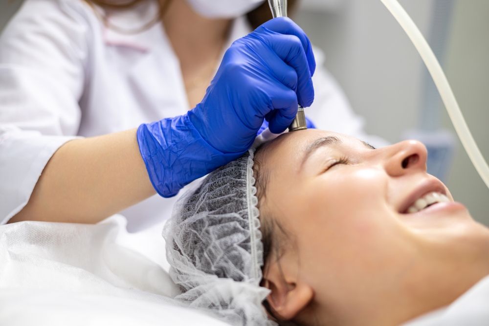 Gloved Esthetician Applying Treatment — A9 Skin and Hair Clinic In Westmead, NSW