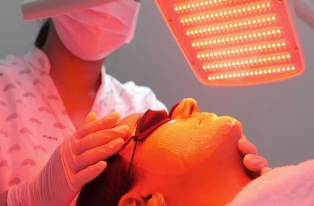 Clinician Performing Red Light Therapy on a Patient’s Face — A9 Skin and Hair Clinic In Westmead, NSW