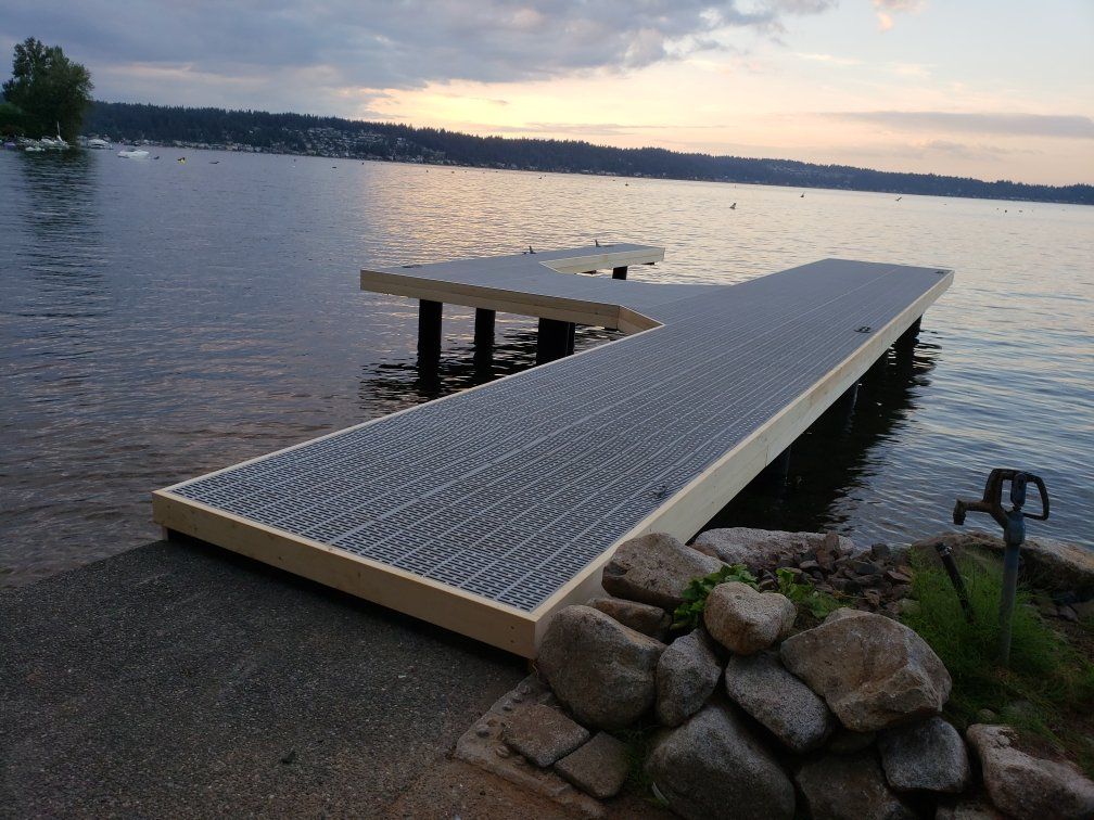 A dock is sitting on the shore of a lake