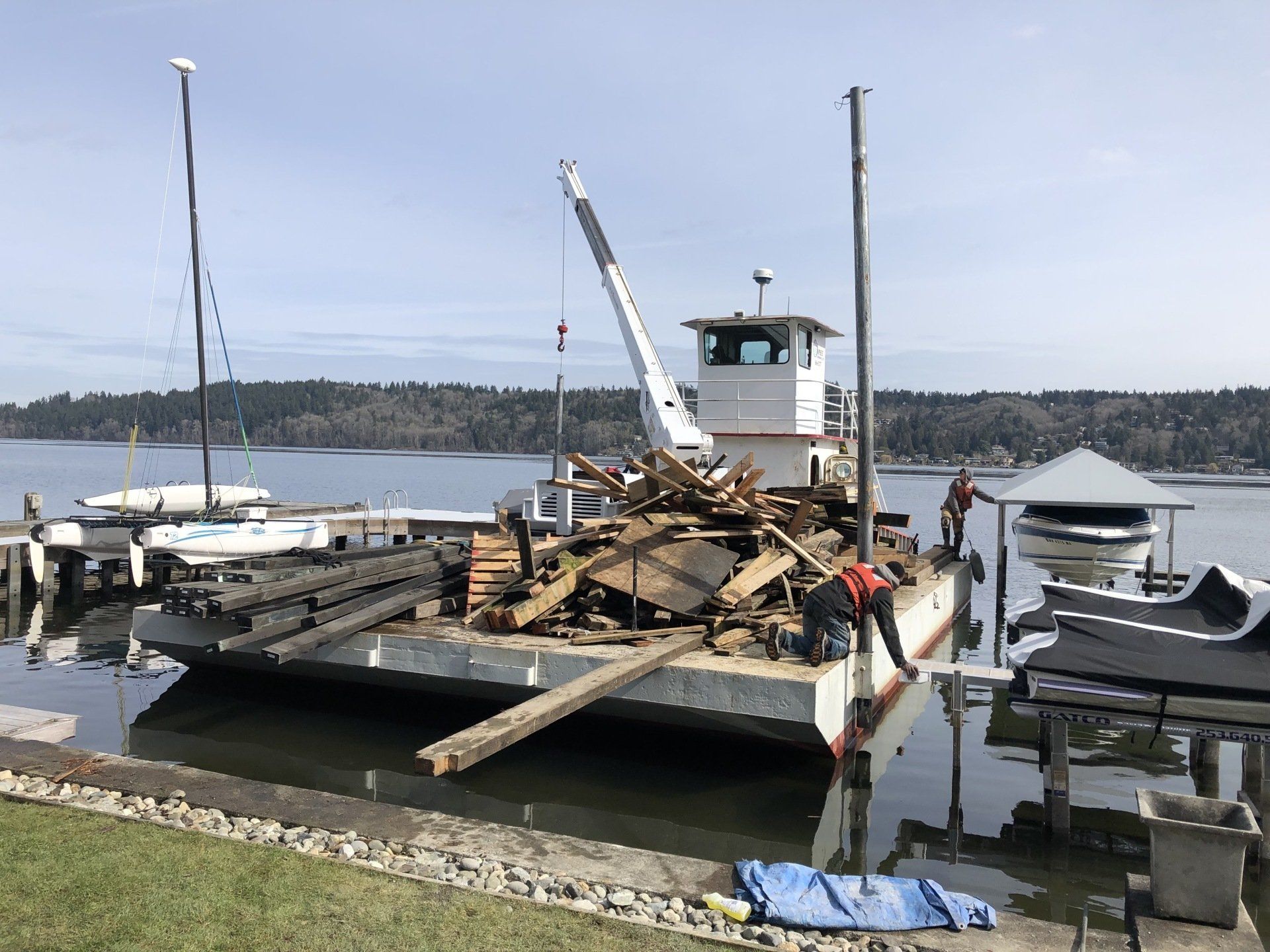 A boat with a crane on top of it is in the water