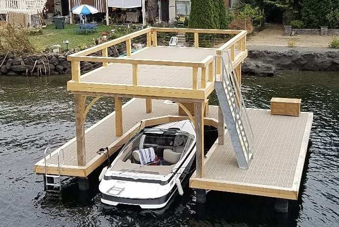 A boat is docked on a wooden dock with stairs